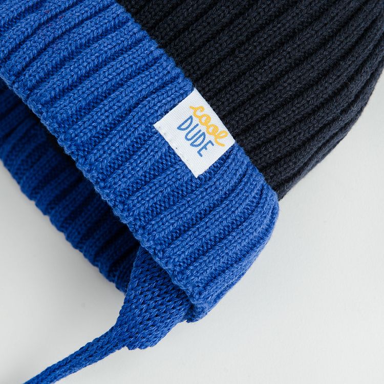 Blue and black cap with pom pom