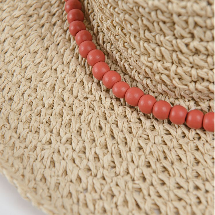 Light beige brimmed Panama hat with coral beads