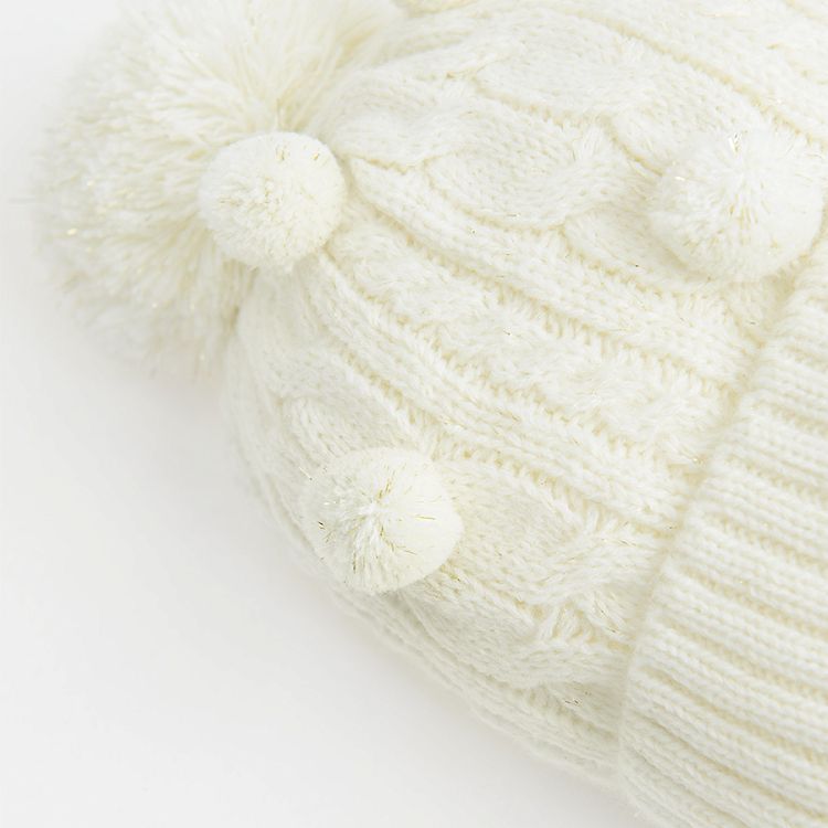 White cap with pom pom and decorative balls