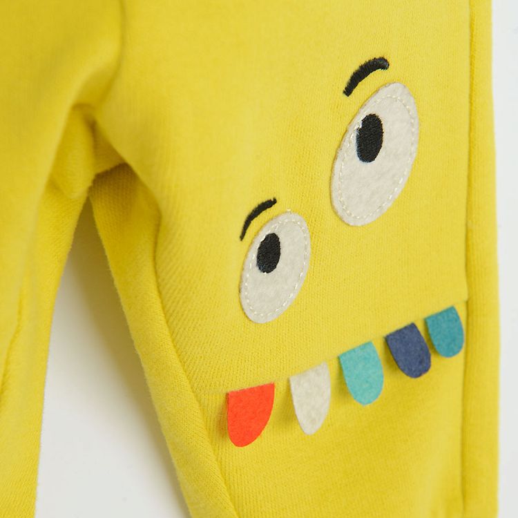 Yellow jogging pants with funny face on knee