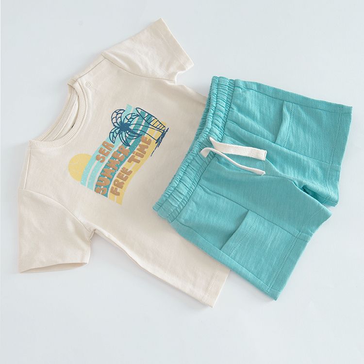 Beige short sleeve T-shirt with SEA SUMMER FREE TIME print and blue shorts with back pocket