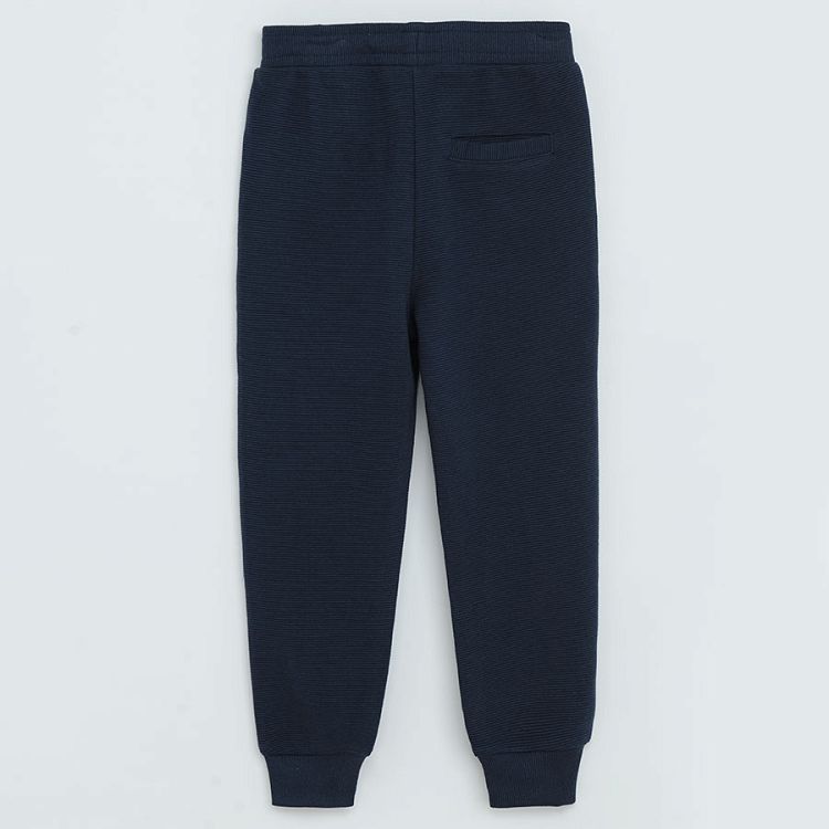 Dark blue jogging pants with cord and elastic around the ankles