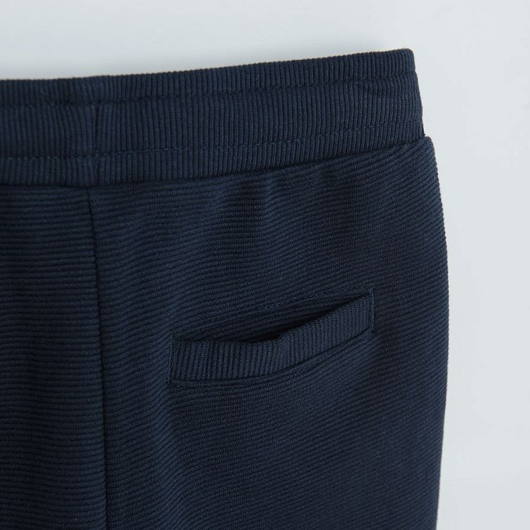 Dark blue jogging pants with cord and elastic around the ankles