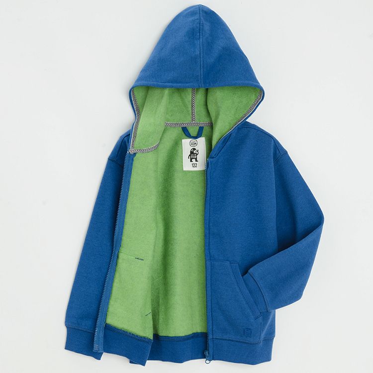 Blue zip through sweatshirt with fluo green lining on the hood