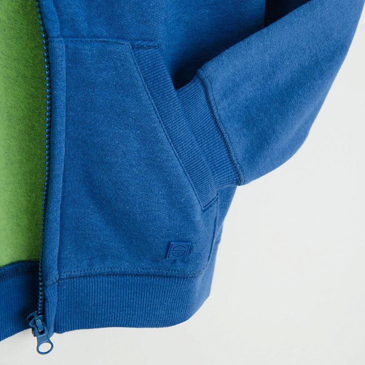 Blue zip through sweatshirt with fluo green lining on the hood