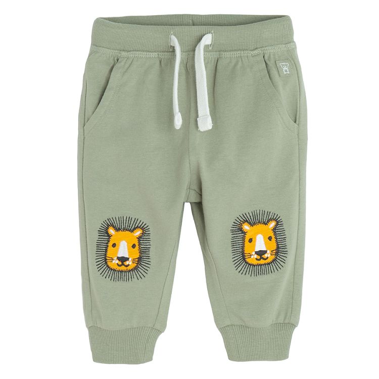 Green jogging pants with lions head on the knees