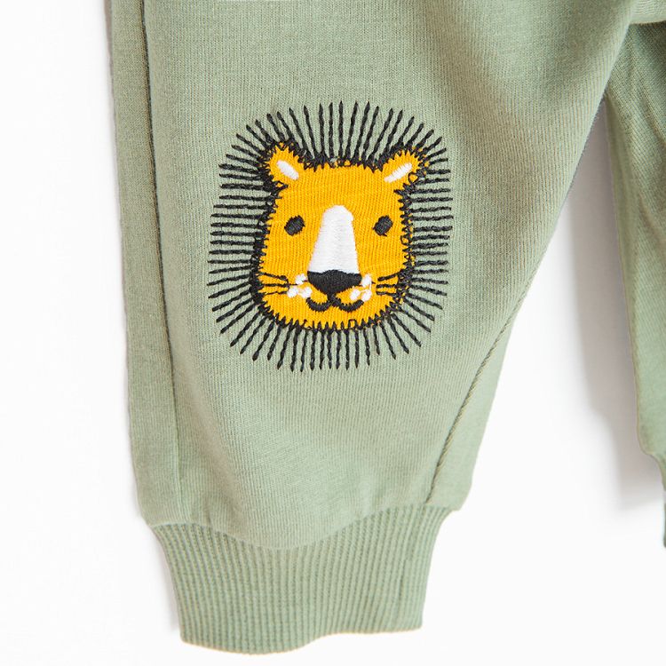 Green jogging pants with lions head on the knees