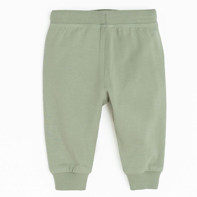 Green jogging pants with lions head on the knees