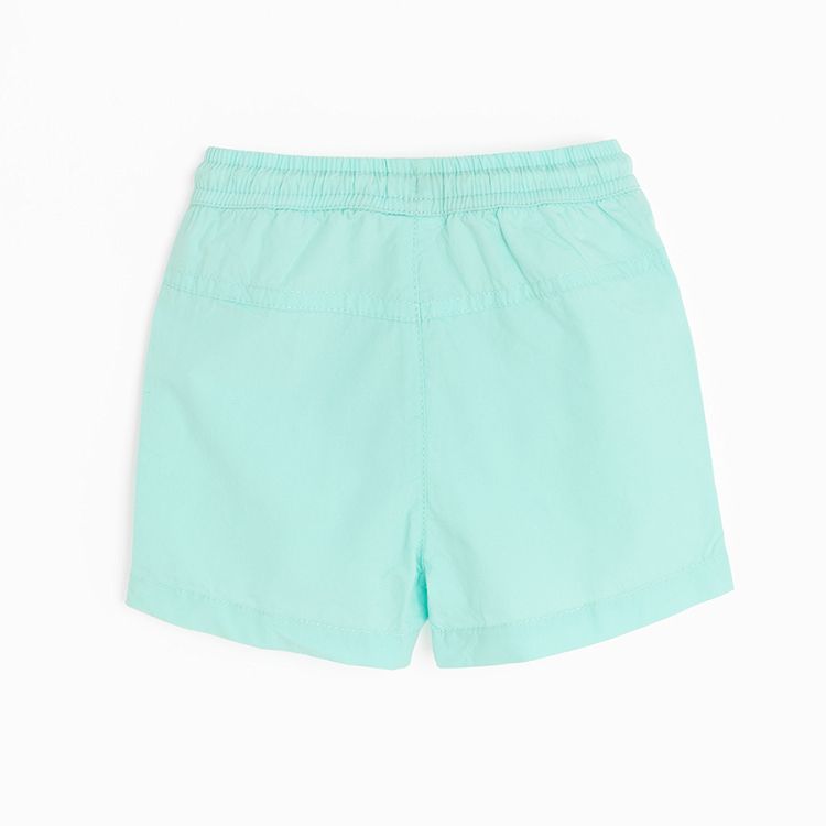 Light turquoise shorts with cord on the waist