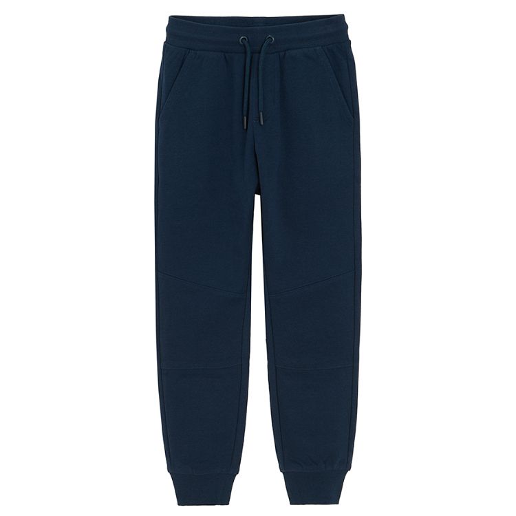 Dark blue sweatpants with elastic around ankles and cord