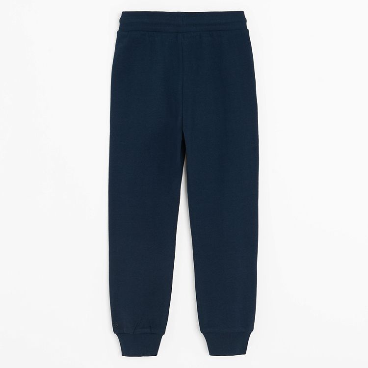 Dark blue sweatpants with elastic around ankles and cord