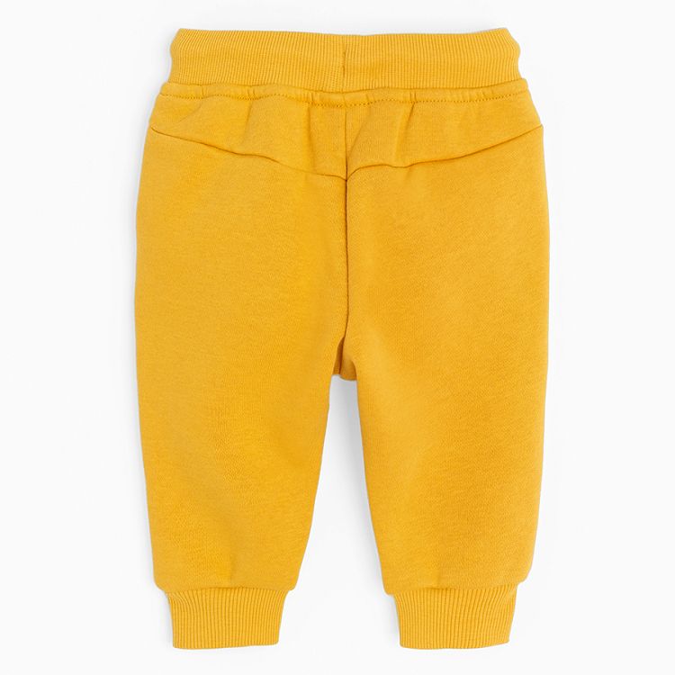 Yellow jogging pants with corded waist and elastic around the ankles