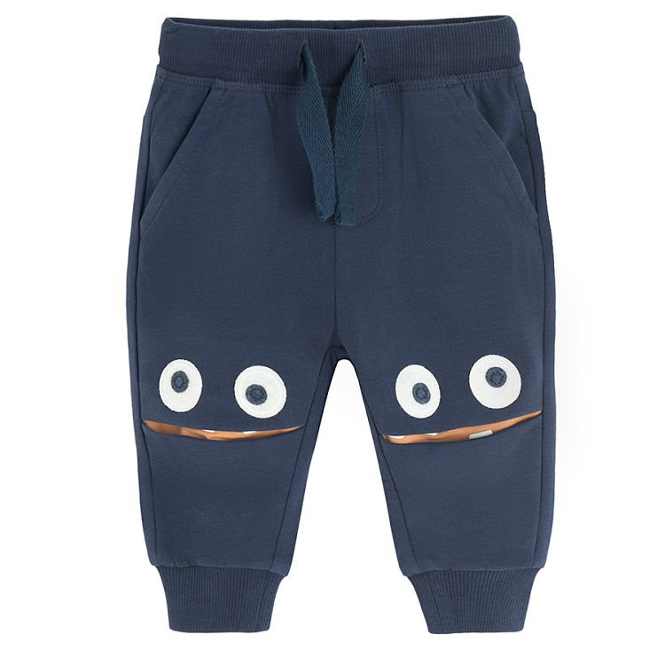 Dark blue jogging pants with monster face on the knees print