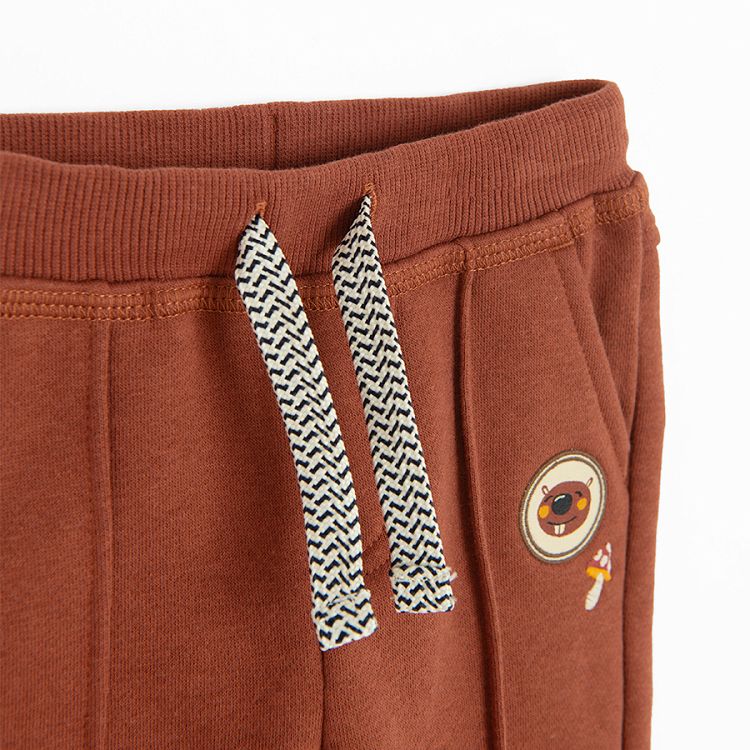 Brown jogging pants with bear print