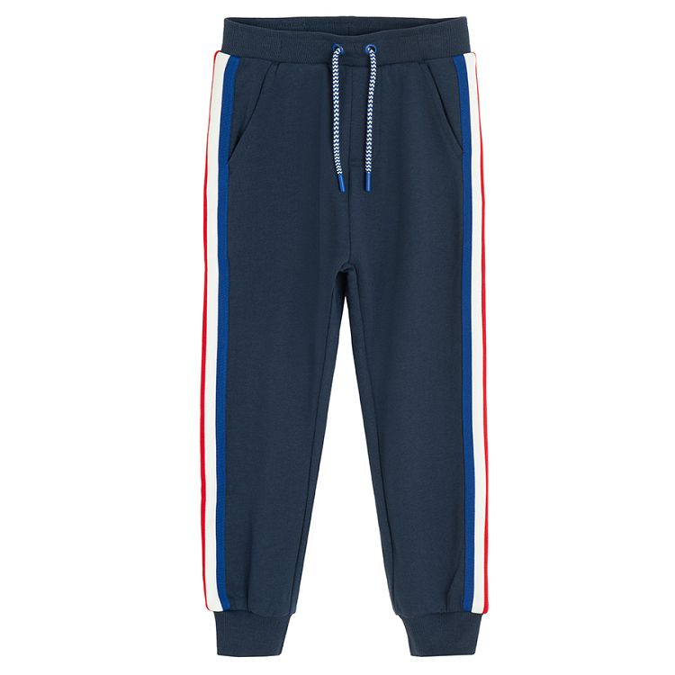 Blue jogging pants with white and red stripes on the side