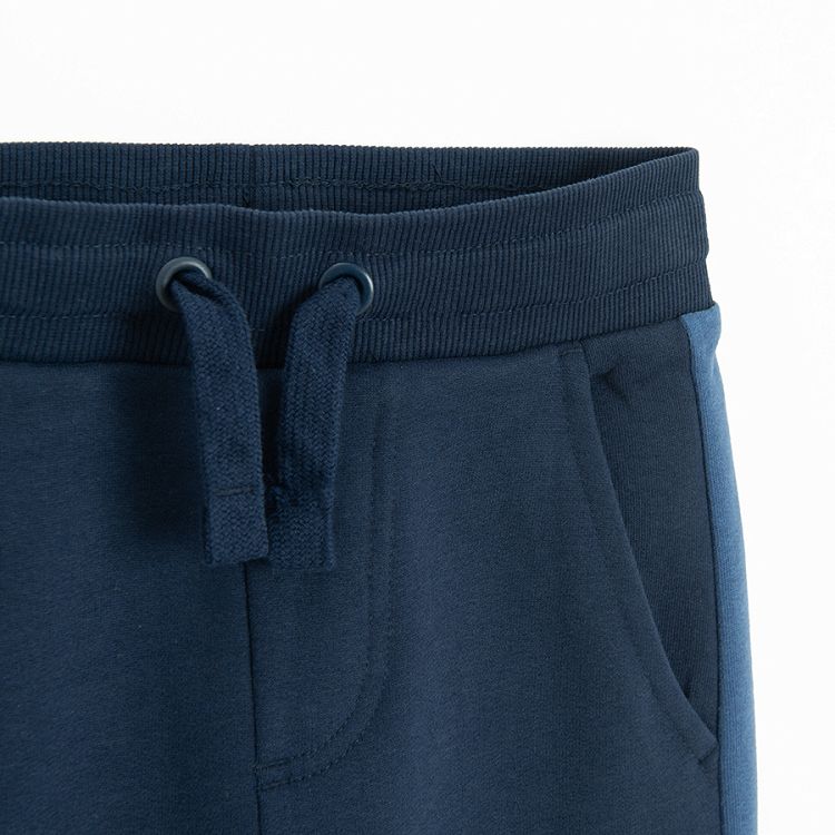 Blue sweatpants with stripe on the side and cord