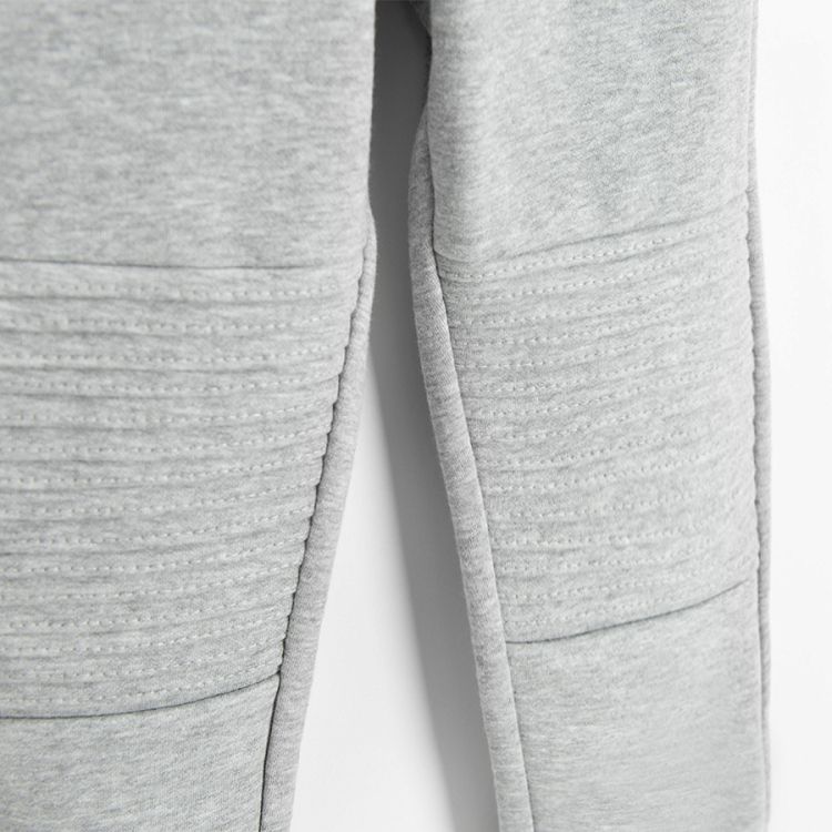 Grey jogging pants with design on the knees