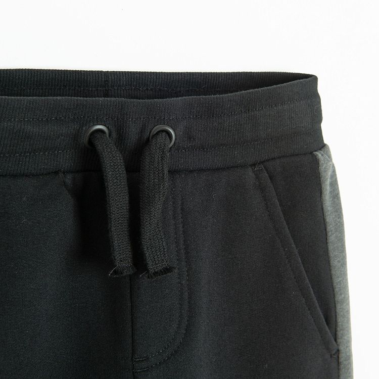 Black sweatpants with grey strip on the side