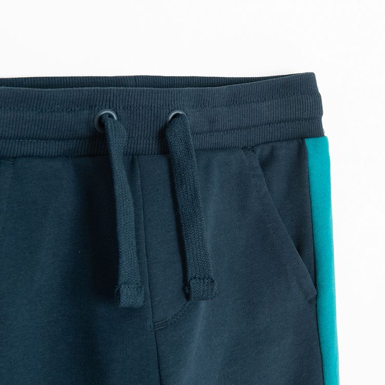 Blue jogging pants with light blue stip on the side