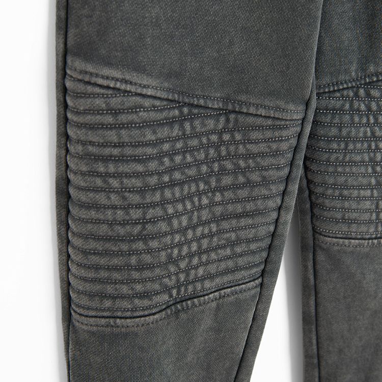 Grey jogging pants with corded waist and elastic around the ankles