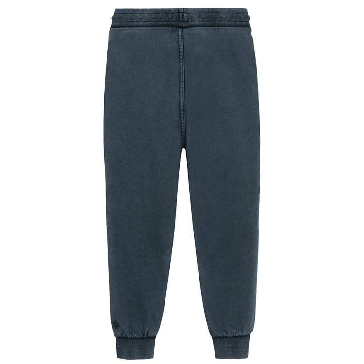 Blue jogging pants with corded waist and elastic around the ankles