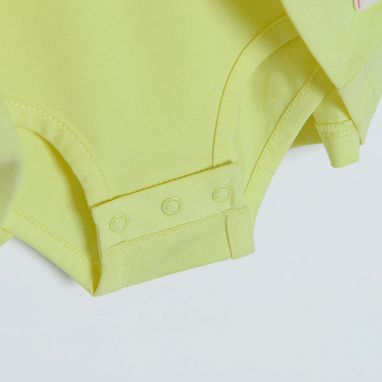 Yellow short sleeve bodysuit with skirt and buttons on the top