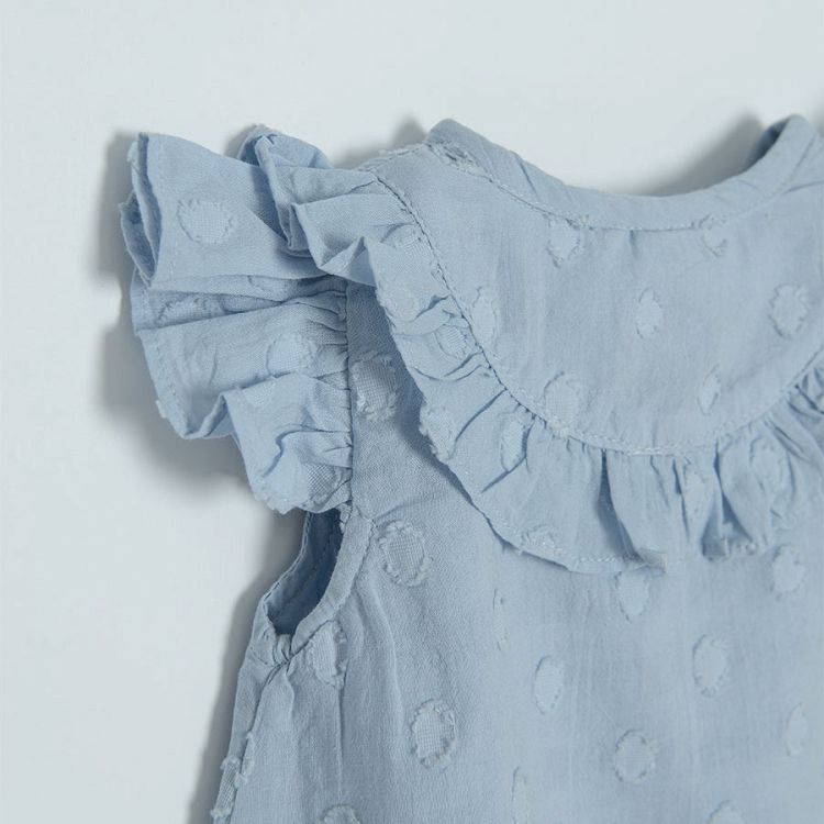 Light blue sleeveless shirt with ruffles around the neckline