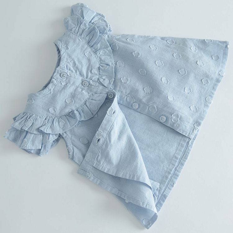 Light blue sleeveless shirt with ruffles around the neckline