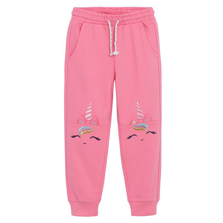 Pink jogging pants with unicorn print on the knees