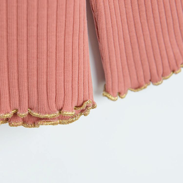 Pink fitted long sleeve blouse with gold thread at the bottom and the sleeves