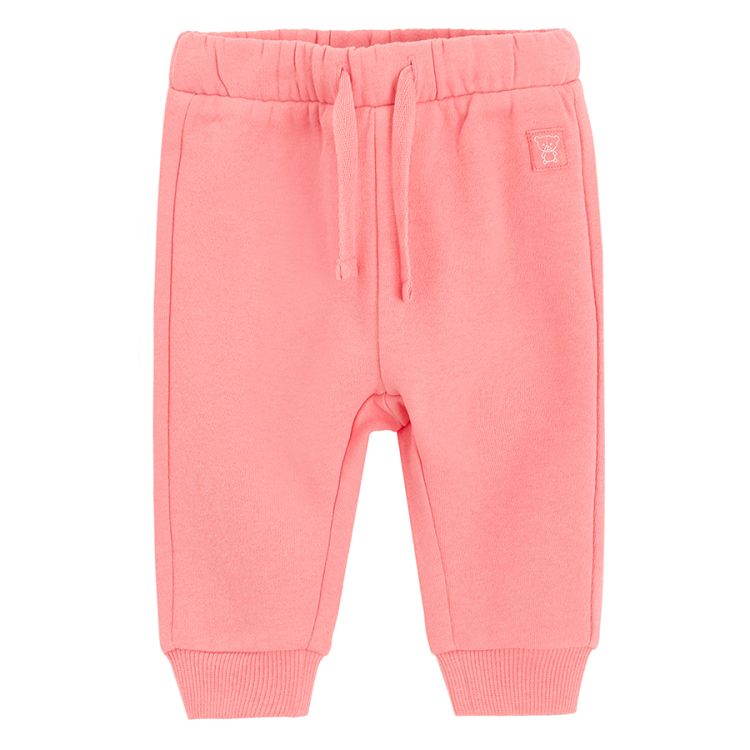 Pink sweatpants with elastic around the ankles and cord on the waist