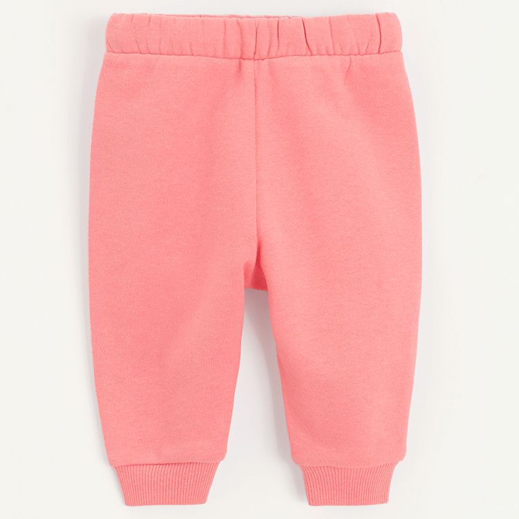 Pink sweatpants with elastic around the ankles and cord on the waist