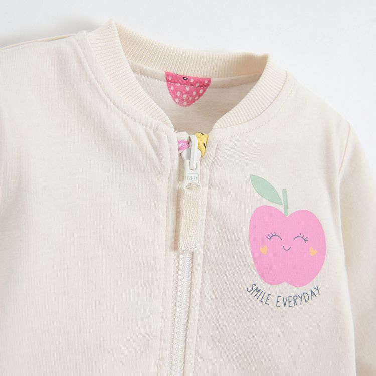 White sweatshirt with fruit print and purple reversible sweatshirt