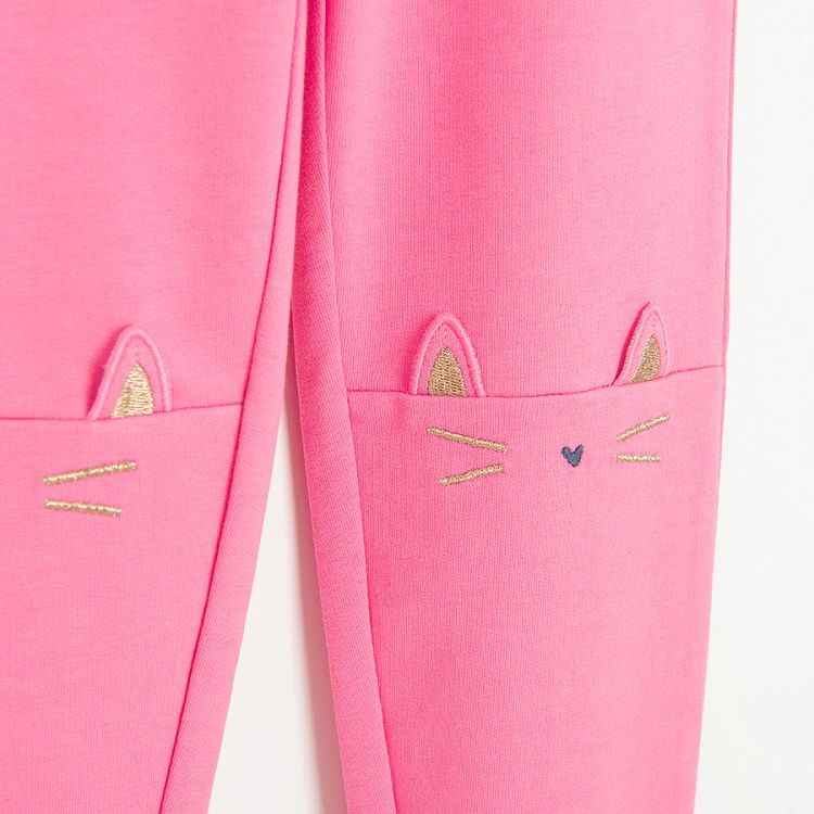 Pink leggings with kitten face print on the knees