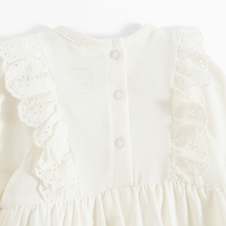 Ecru bodysuit/dress with embroidery around the neck line