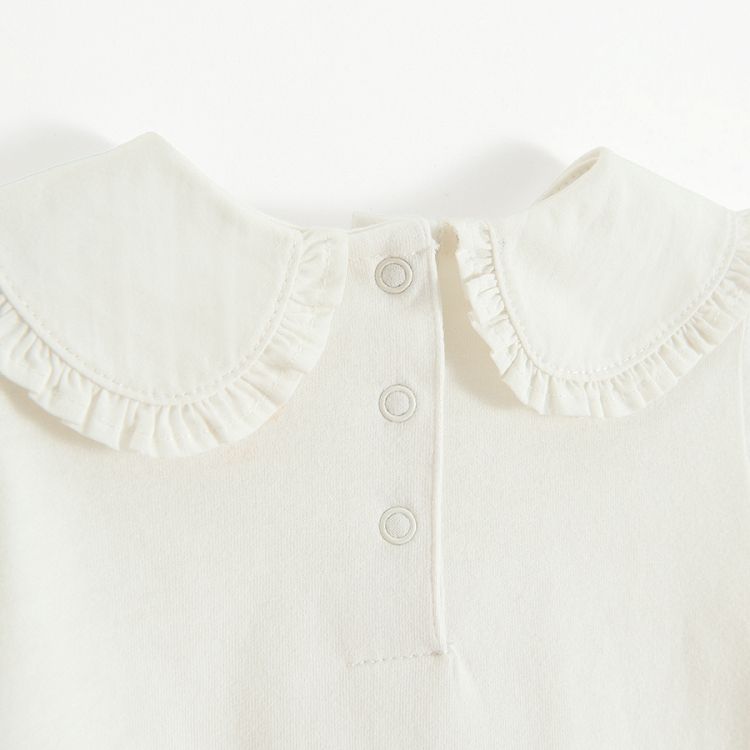 White long sleeve blouse with round collar and elastic around wrists