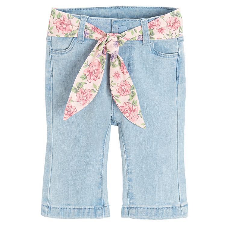 Light blue denim trousers with floral belt