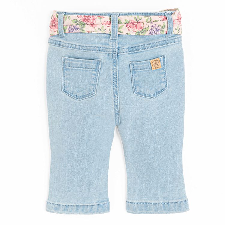 Light blue denim trousers with floral belt