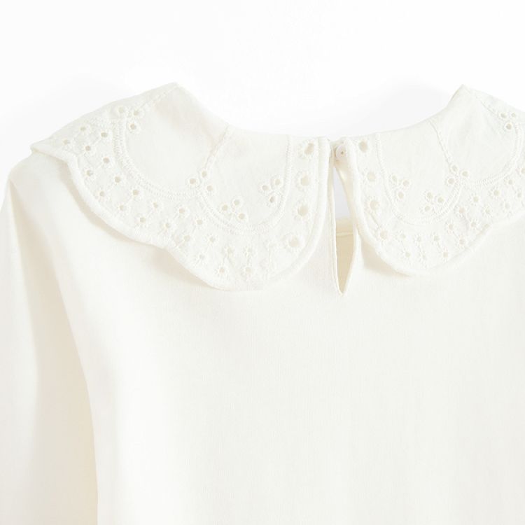 White long sleeve blouse with ruffle on the neckline