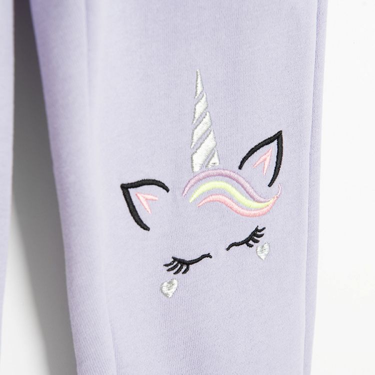 Purple jogging pants with unicorn print on the knees