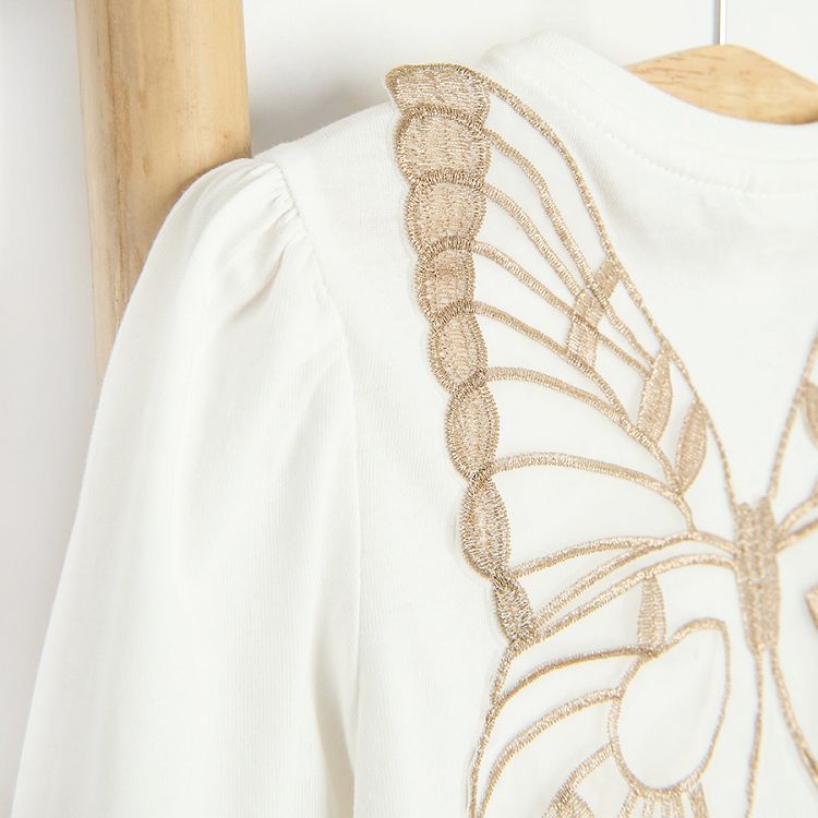 White long sleeve blouse with gold stars with fairy's wings on the back and skirt with stars set