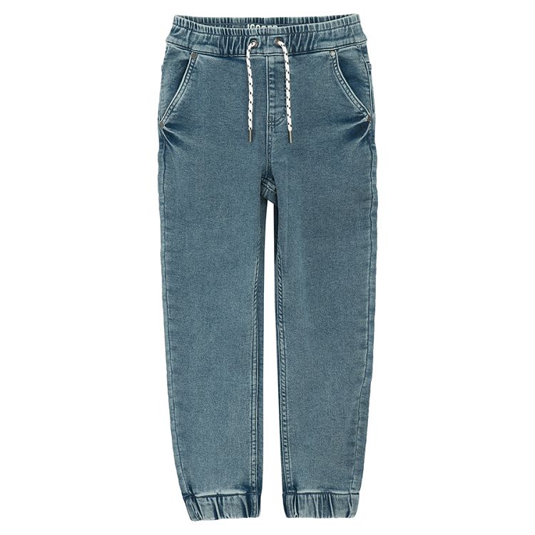 Blue denim pants with cord and elastic around the ankles