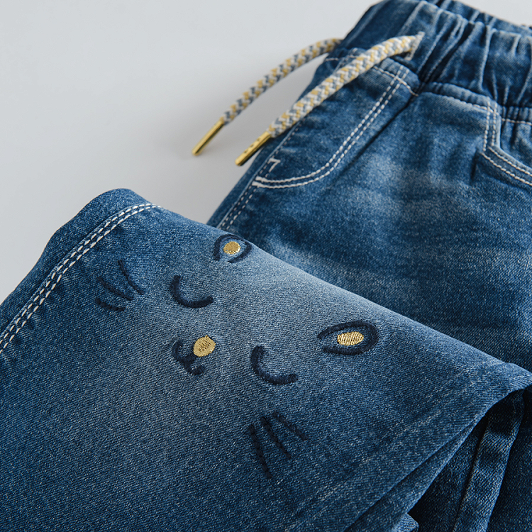 Denim trousers with adjustable waist and kitten face on the knees