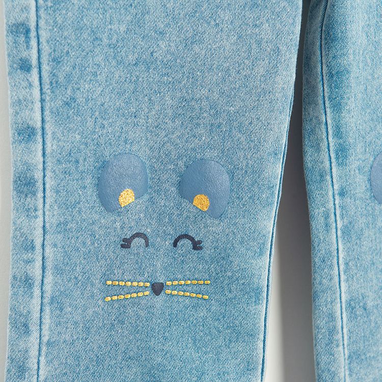 Light blue denim pants with kitten pattern on the knees