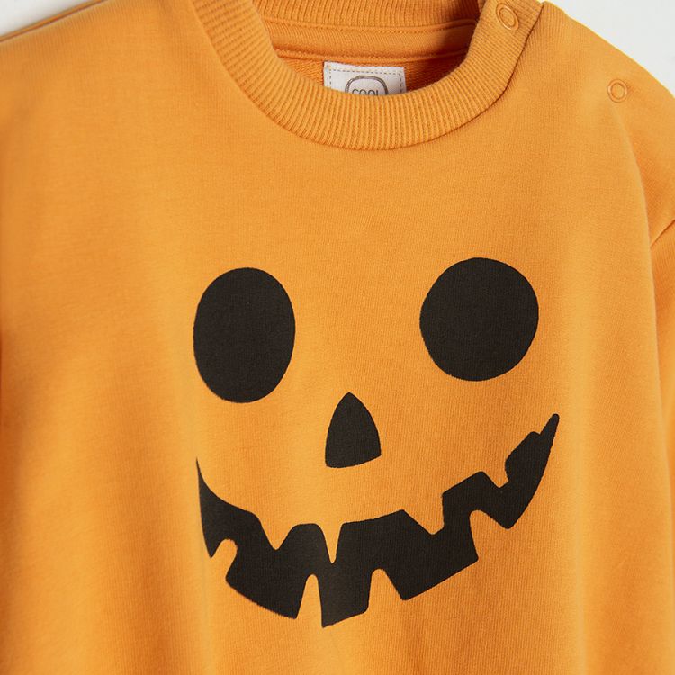 Orange Halloween long sleeve bodysuit and black footed leggings with BOO print