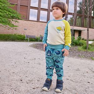 Light blue jogging pants with monsters print