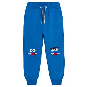 Blue jogging pants with adjustable waste and funny faces on the knees