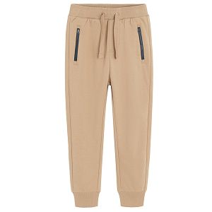 Brown jogging pants with corded waist and elastic around the ankles