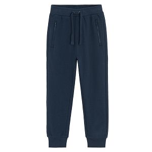 Blue jogging pants with corded waist and elastic around the ankles
