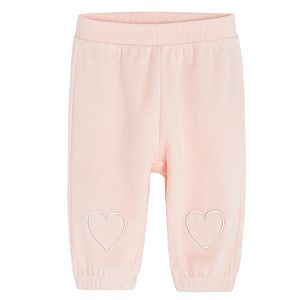 Pink velvet jogging pants with hearts on the ankles